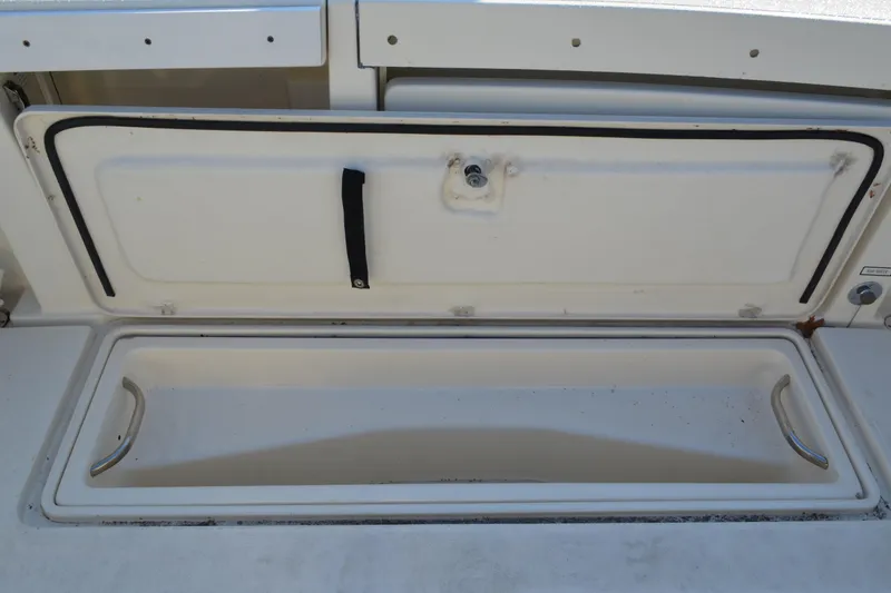 Slide: The Image of Open storage compartment on a 2003 Pursuit 3000 Express boat. - 25