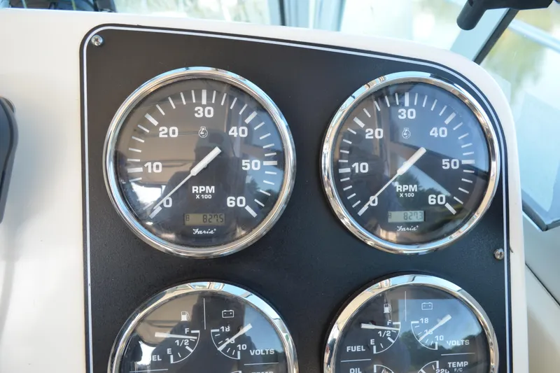Slide: The Image of Dashboard gauges of a 2003 Pursuit 3000 Express boat, showing RPM and fuel levels. - 31