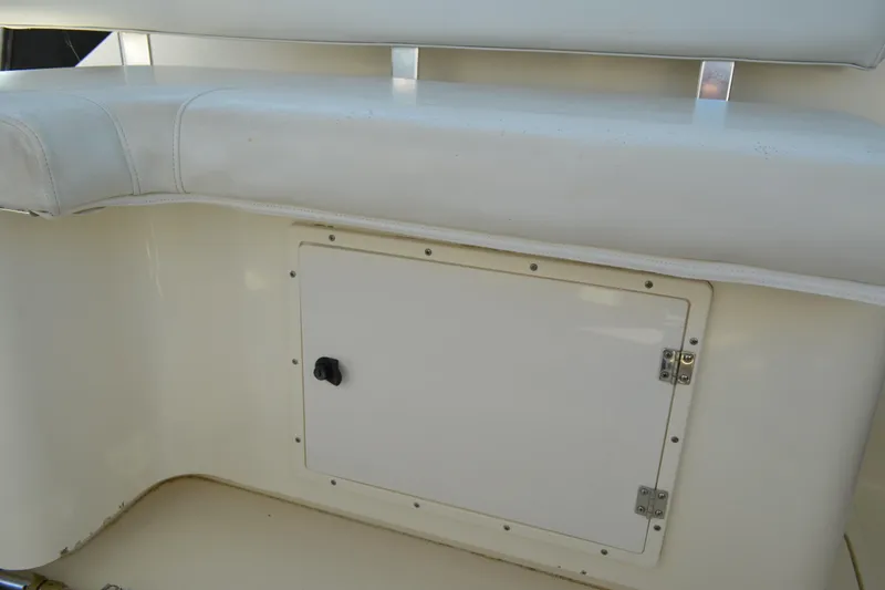 Slide: The Image of 2003 Pursuit 3000 Express boat seat and storage compartment detail. - 33