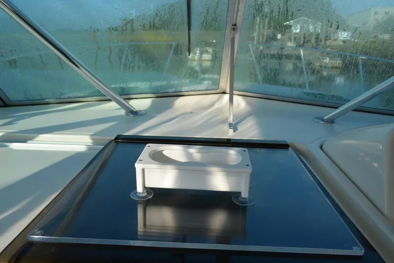 Slide: The Image of 2003 Pursuit 3000 Express boat interior with windshield and mounted equipment. - 35