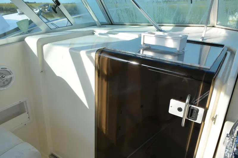 Slide: The Image of 2003 Pursuit 3000 Express boat interior with cabin door and windows. - 36