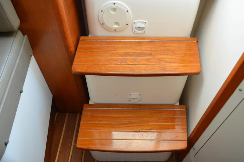 Slide: The Image of Wooden steps inside a 2003 Pursuit 3000 Express boat cabin. - 37