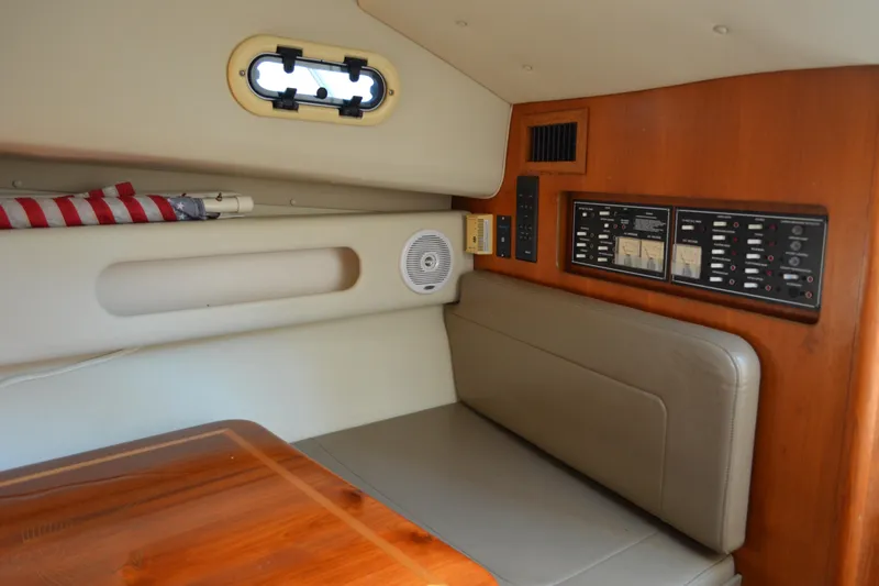 Slide: The Image of 2003 Pursuit 3000 Express cabin interior with control panel and seating area. - 43