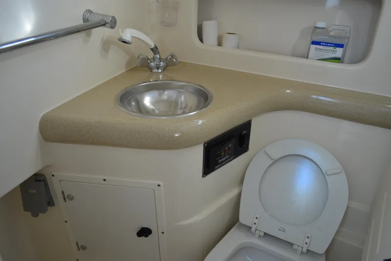 Slide: The Image of 2003 Pursuit 3000 Express boat bathroom with sink and toilet. - 51
