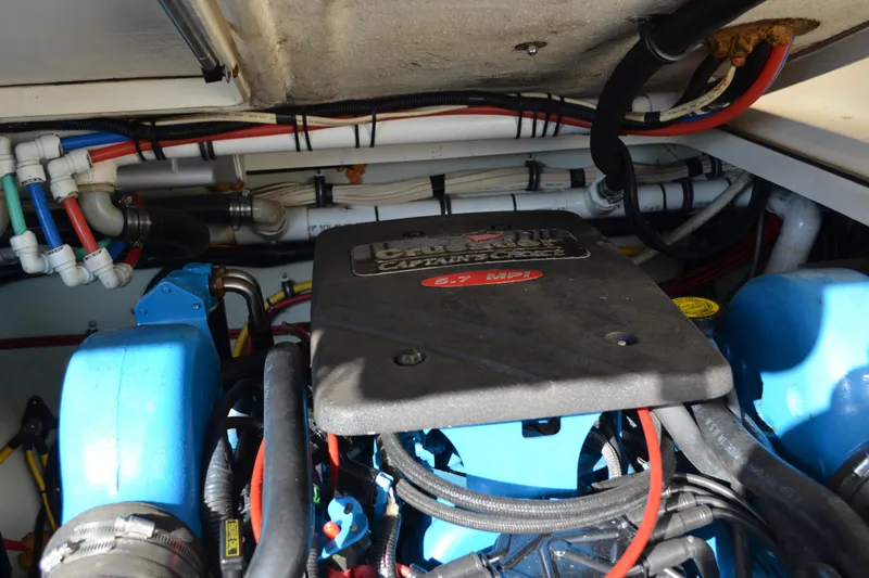 Slide: The Image of Engine compartment of a 2003 Pursuit 3000 Express boat, featuring a 5.7 MPI engine. - 59