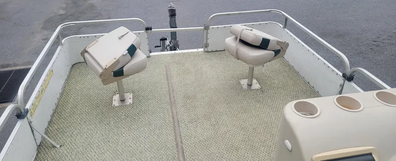 Slide: The Image of 1999 Landau 18 FISH boat interior with swivel seats and carpeted deck. - 10