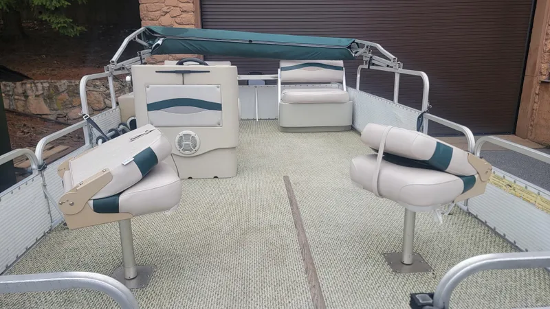 Slide: The Image of 1999 Landau 18 FISH pontoon boat interior with seating and steering console. - 11