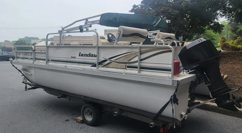 Slide: The Image of 1999 Landau 18 FISH pontoon boat on trailer, parked outdoors. - 5