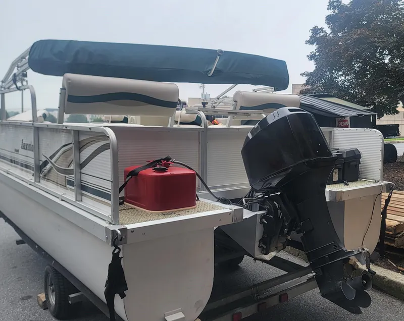 Slide: The Image of 1999 Landau 18 FISH pontoon boat with outboard motor and red fuel tank. - 6
