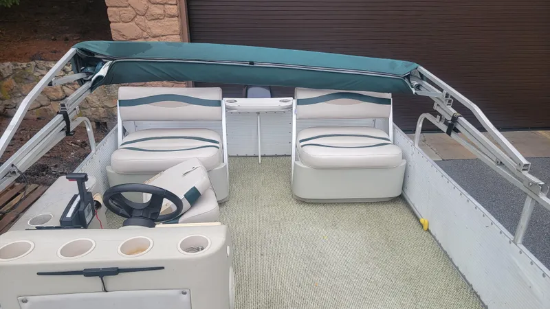 Slide: The Image of 1999 Landau 18 FISH pontoon boat interior with seating and steering console. - 8