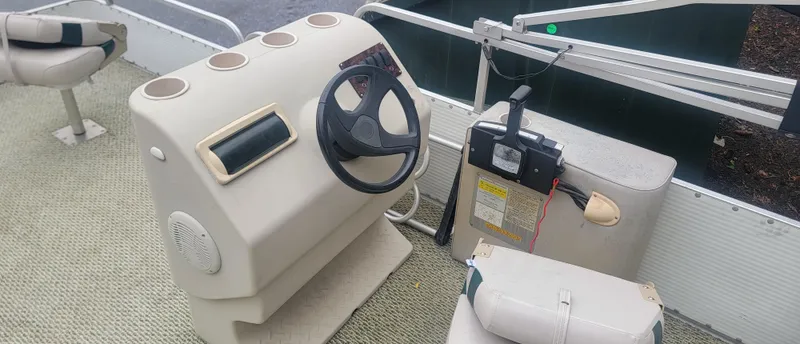 Slide: The Image of 1999 Landau 18 FISH boat interior with steering wheel and control panel. - 9