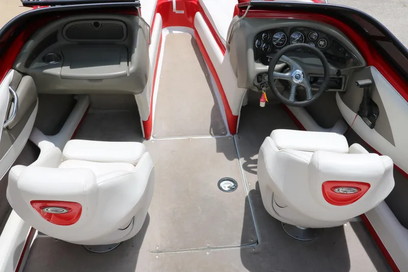Slide: The Image of 2006 Crownline 21 SS-LPX boat interior with red and white seating, steering wheel, and dashboard. - 11