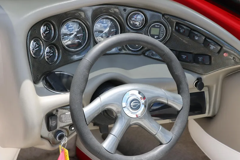 Slide: The Image of Dashboard of a 2006 Crownline 21 SS-LPX boat with gauges and steering wheel. - 20