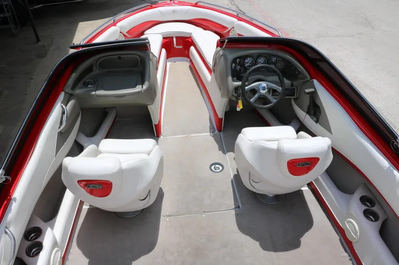 Slide: The Image of 2006 Crownline 21 SS-LPX boat interior with red and white seating, steering wheel, and dashboard. - 24