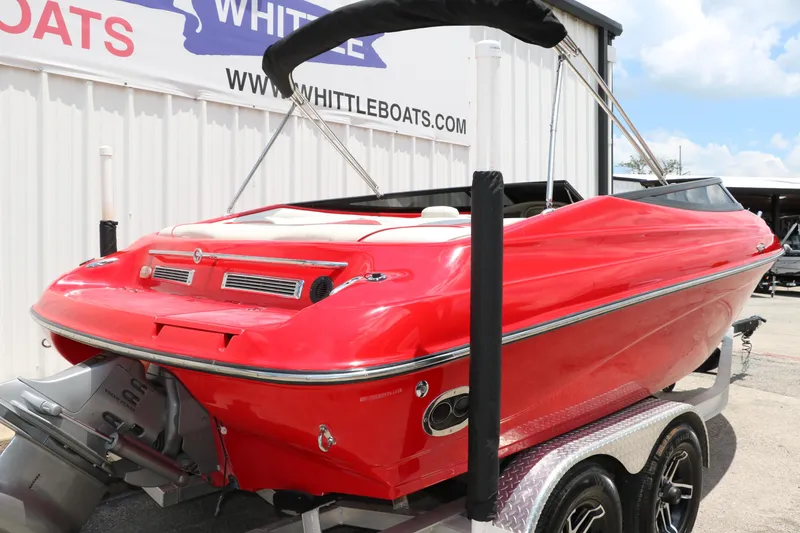 Slide: The Image of Red 2006 Crownline 21 SS-LPX boat on trailer, displayed at Whittle Boats dealership. - 3