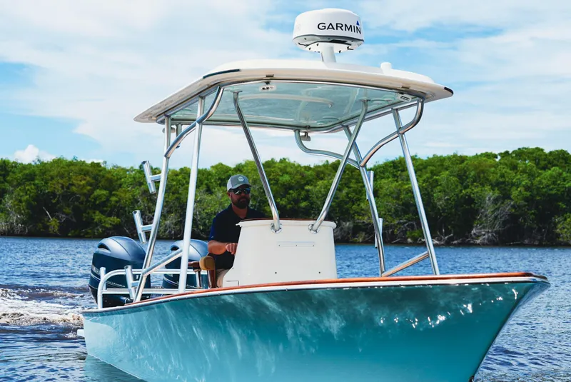 Slide: The Image of 1969 SeaCraft Potter hull boat cruising on water with lush greenery in the background. - 12