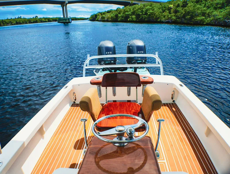 Slide: The Image of 1969 SeaCraft Potter hull boat with dual engines on a scenic river. - 3