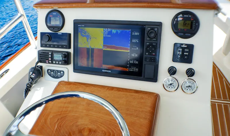 Slide: The Image of 1969 SeaCraft Potter hull dashboard with navigation equipment and wooden steering wheel. - 6