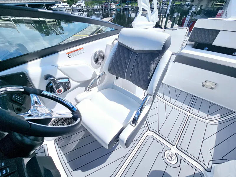 Slide: The Image of 2025 Monterey M-45 boat interior with sleek steering and cushioned seating. - 21