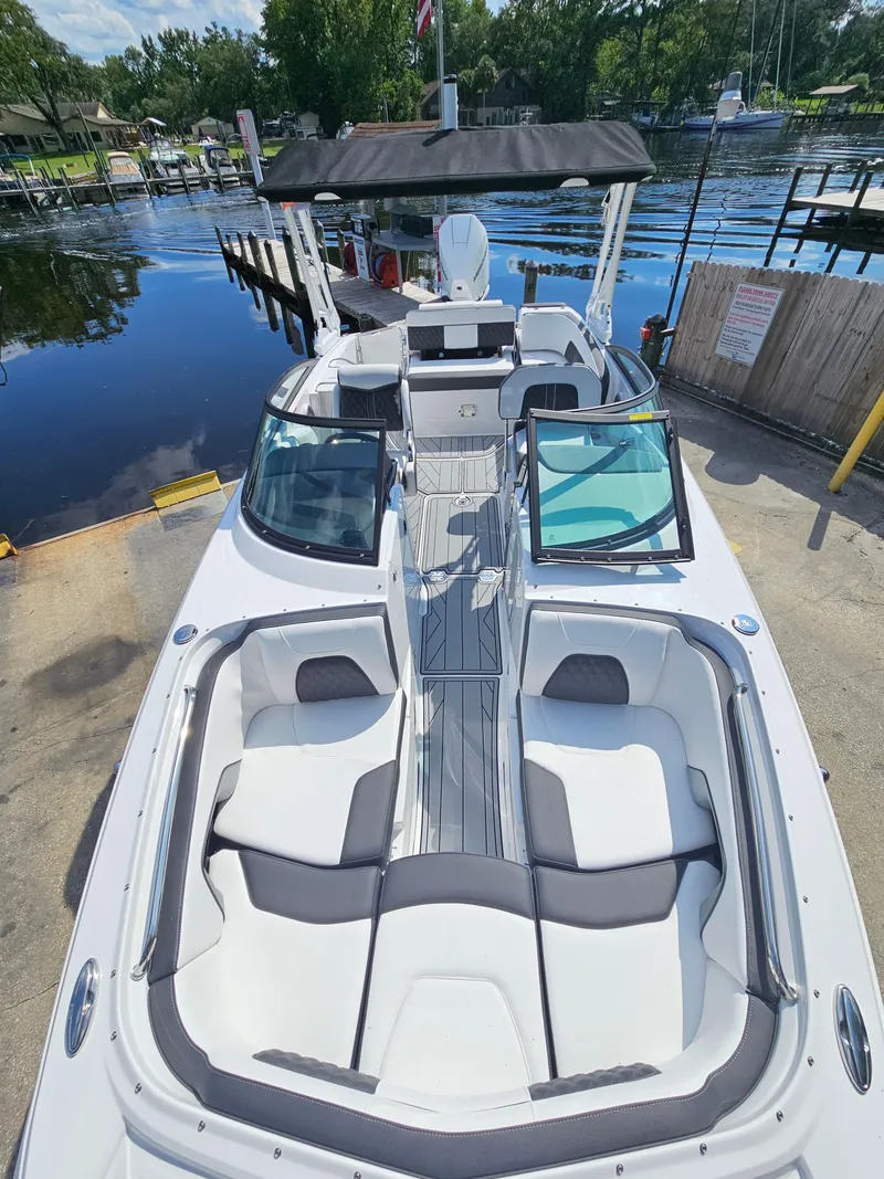 Slide: The Image of 2025 Monterey M-45 boat docked, featuring spacious seating and sleek design. - 26