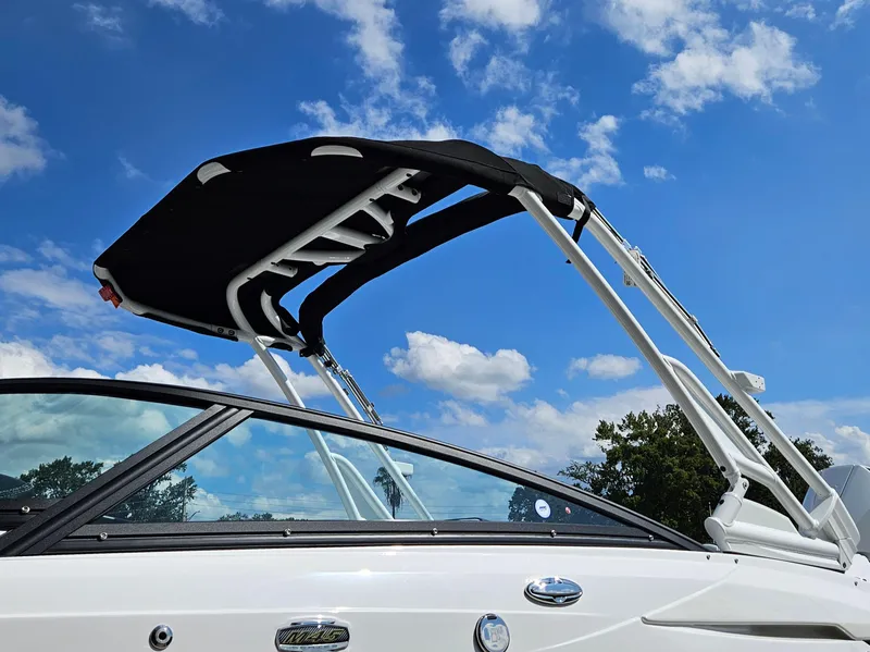 Slide: The Image of 2025 Monterey M-45 boat with black canopy against a blue sky. - 28