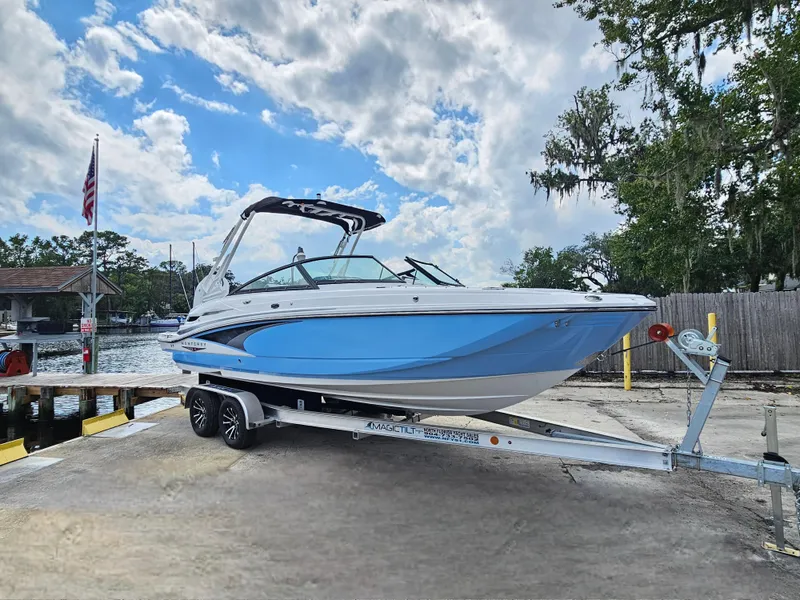 Slide: The Image of 2025 Monterey M-45 boat on trailer by waterfront, under partly cloudy sky. - 4
