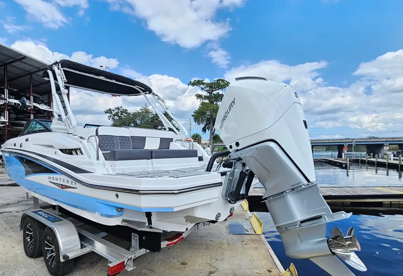 Slide: The Image of 2025 Monterey M-45 boat on trailer by waterfront, featuring sleek design and powerful outboard motor. - 6