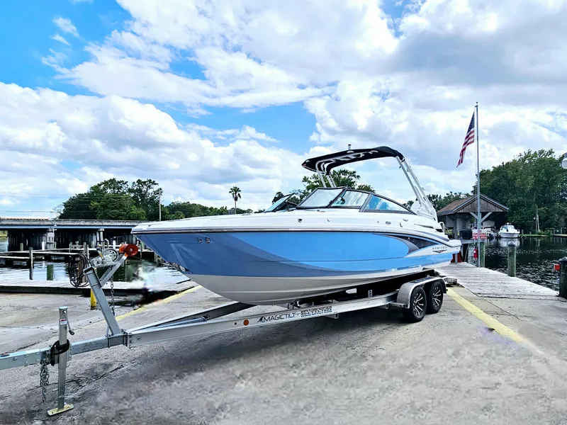Slide: The Image of 2025 Monterey M-45 boat on trailer by waterfront, under blue sky. - 3