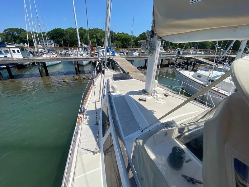 Slide: The Image of 1986 S2 11 Center Cockpit sailboat docked at marina under clear blue sky. - 13