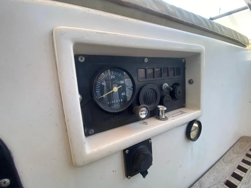 Slide: The Image of 1986 S2 11 Center Cockpit control panel with Yanmar tachometer and switches. - 22