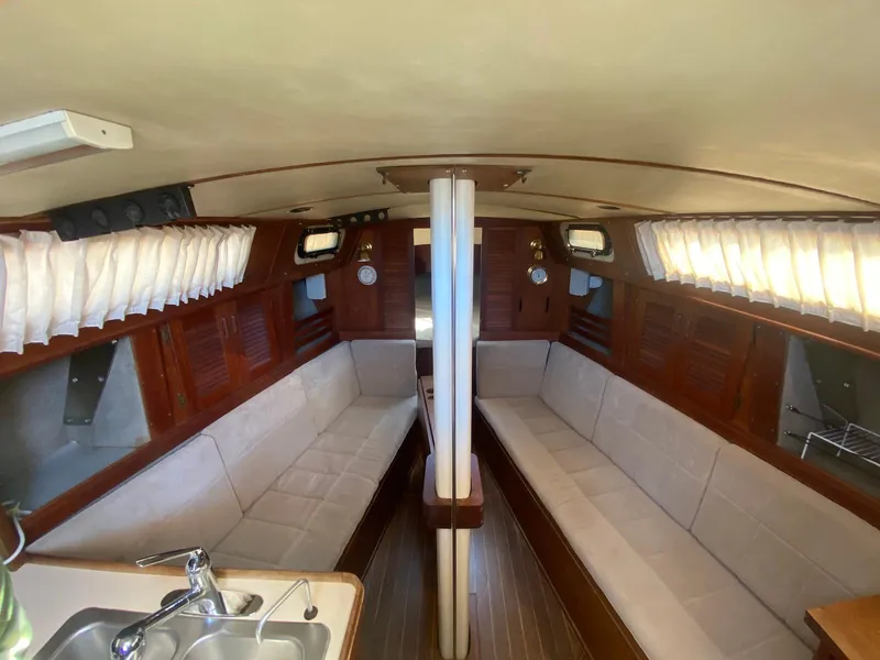 Slide: The Image of 1986 S2 11 Center Cockpit interior with wood finish and beige seating. - 25