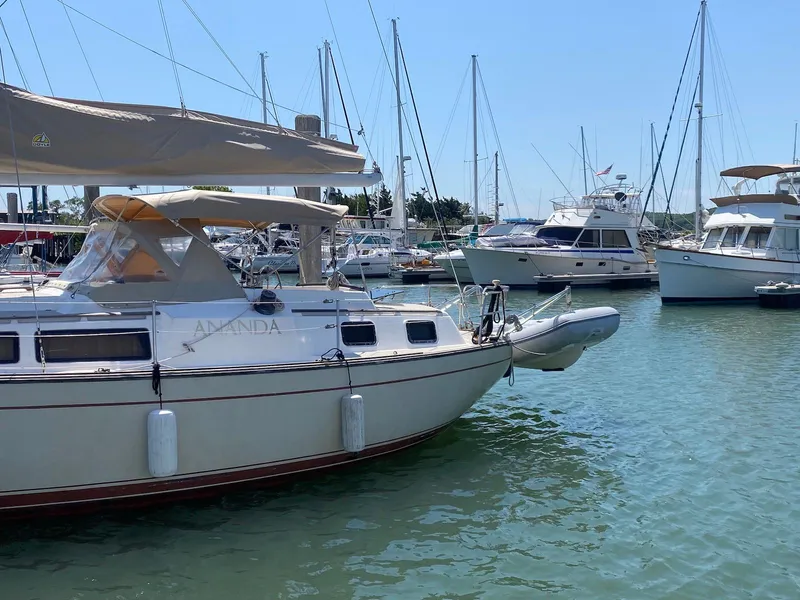 Slide: The Image of 1986 S2 11 Center Cockpit sailboat docked in a marina with other boats. - 3