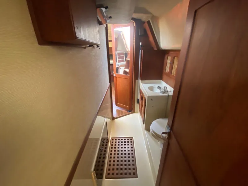 Slide: The Image of 1986 S2 11 Center Cockpit interior with wooden cabinetry and compact bathroom. - 32