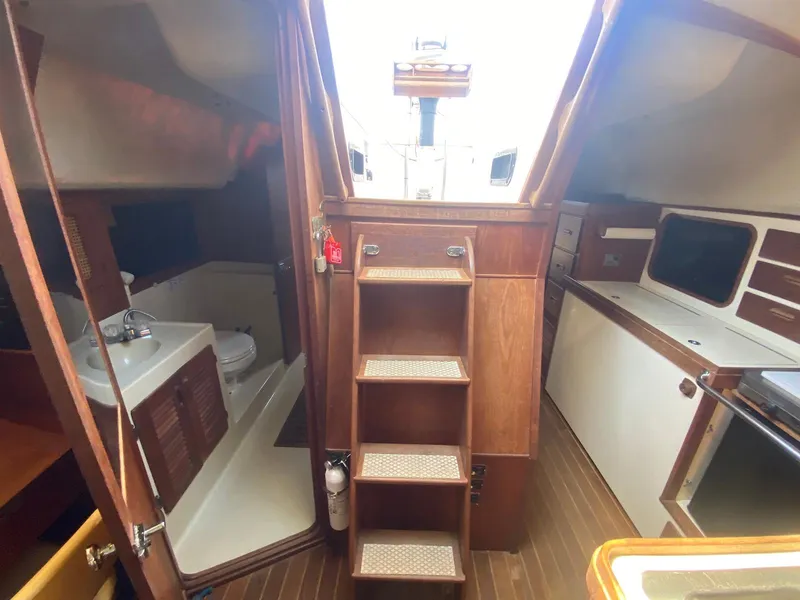 Slide: The Image of Interior of 1986 S2 11 Center Cockpit sailboat with wooden cabinetry and compact bathroom. - 35