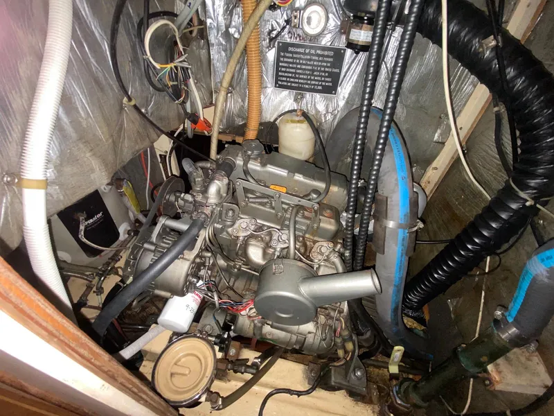 Slide: The Image of Engine compartment of a 1986 S2 11 Center Cockpit sailboat, showing detailed machinery. - 38