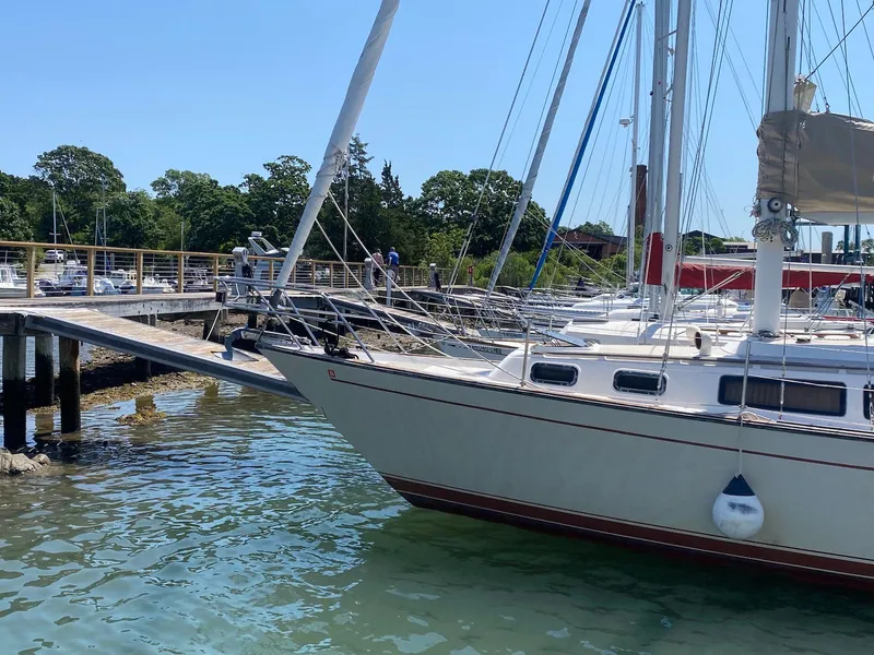 Slide: The Image of 1986 S2 11 Center Cockpit sailboat docked at a marina on a sunny day. - 4