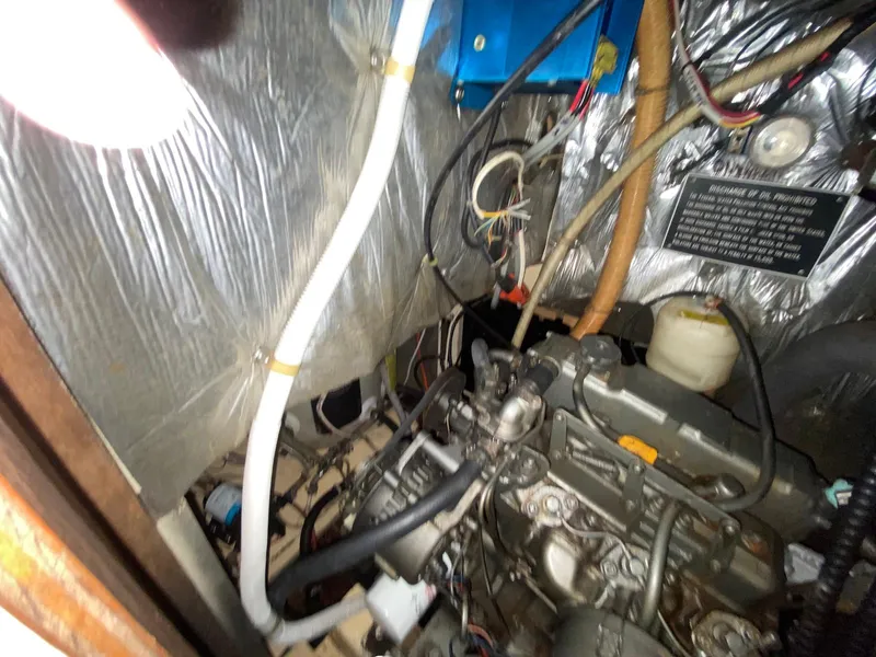 Slide: The Image of Engine compartment of a 1986 S2 11 Center Cockpit sailboat, showing wiring and components. - 40