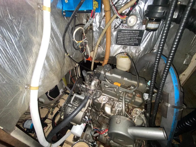 Slide: The Image of Engine compartment of 1986 S2 11 Center Cockpit sailboat, showing detailed mechanical components. - 41