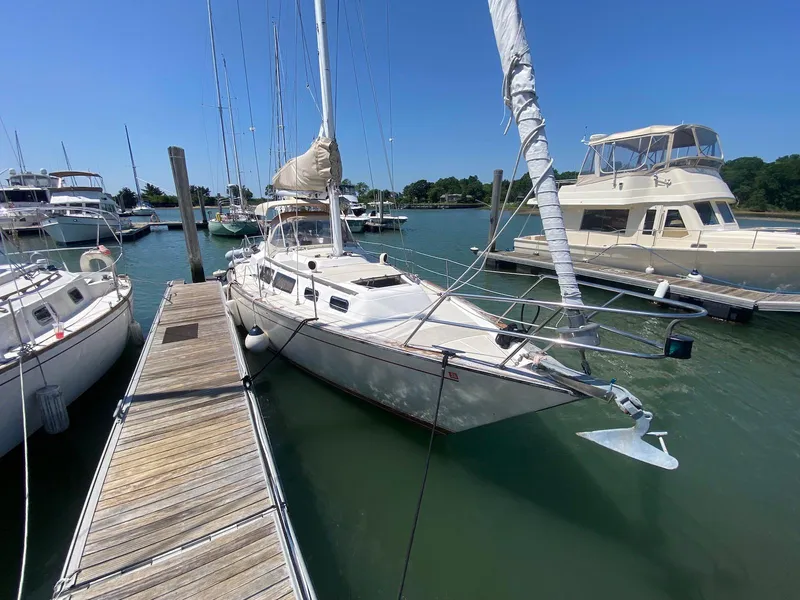 Slide: The Image of 1986 S2 11 Center Cockpit sailboat docked at marina on a sunny day. - 6