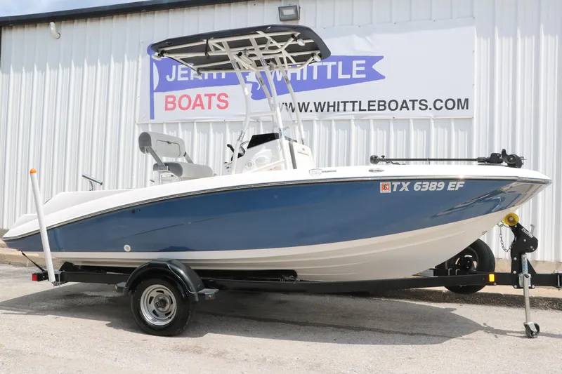 Slide: The Image of 2018 Yamaha Boats 190 FSH Sport in blue on trailer, parked outside dealership. - 1