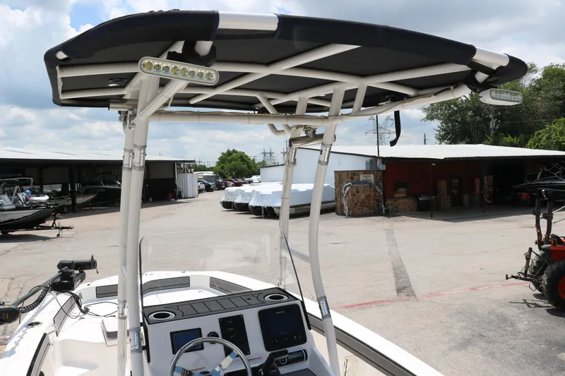 Slide: The Image of 2018 Yamaha Boats 190 FSH Sport with T-top, parked in a marina lot. - 11