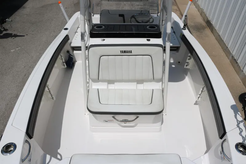 Slide: The Image of 2018 Yamaha Boats 190 FSH Sport interior with white seating and console. - 15