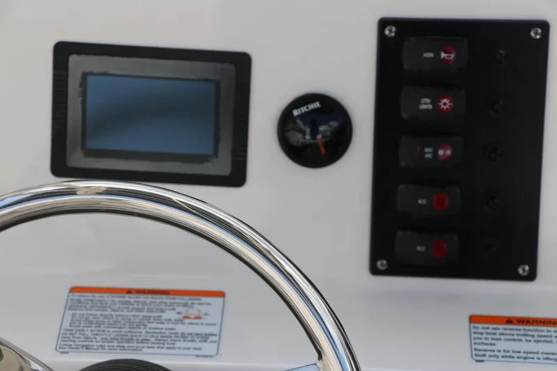 Slide: The Image of Control panel of 2018 Yamaha Boats 190 FSH Sport with steering wheel and switches. - 27