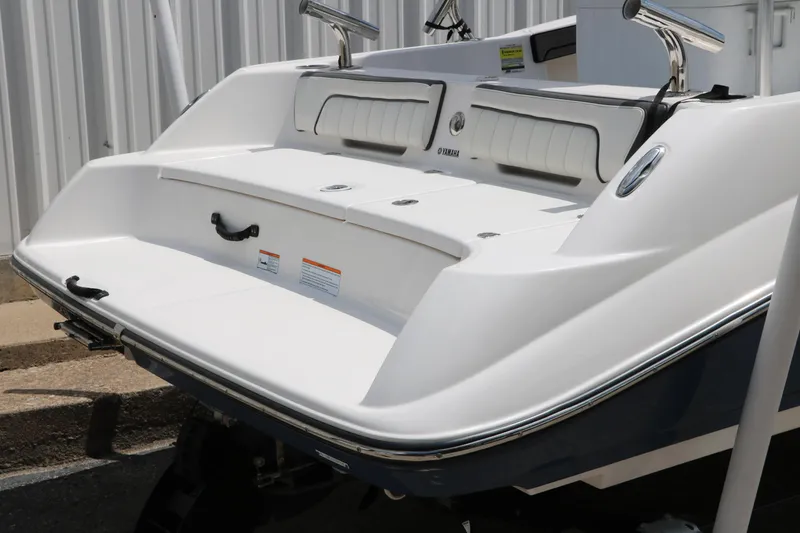 Slide: The Image of 2018 Yamaha Boats 190 FSH Sport, rear view, white exterior, docked. - 4