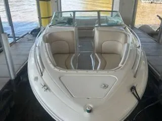 Slide: The Image of 1996 Sea Ray 260 Bow Rider Select, docked, showcasing spacious seating and sleek design. - 10