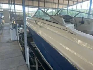 Slide: The Image of 1996 Sea Ray 260 Bow Rider Select in storage, showcasing sleek design and spacious interior. - 12