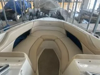 Slide: The Image of 1996 Sea Ray 260 Bow Rider Select with beige seating in a marina. - 2