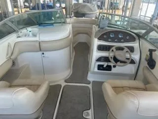 Slide: The Image of 1996 Sea Ray 260 Bow Rider Select interior with beige seating and control panel. - 4