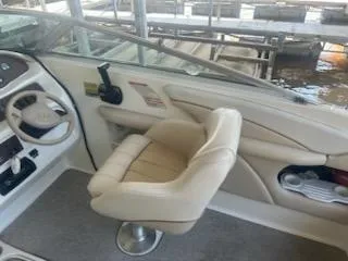 Slide: The Image of 1996 Sea Ray 260 Bow Rider Select interior with beige seating and steering wheel. - 7