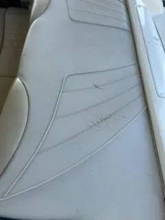Slide: The Image of Close-up of 1996 Sea Ray 260 Bow Rider Select boat seat with visible scratches. - 9